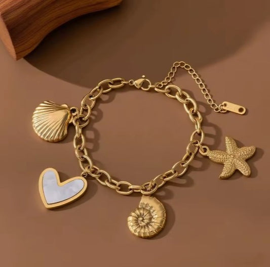 Gold plated Stainless Steel Ocean bracelet with Starfish, Shell Conch, and Heart charms on a cuban chain
